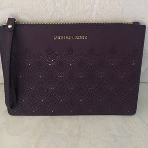 MK Oxblood colored wristlet in perfect condition
